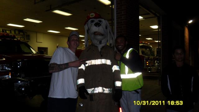 Members Ryan and Jason help Sparky hand out candy to Trick-or-Treaters!