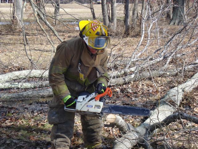 F/F Trossbach cutting a tree during chainsaw training